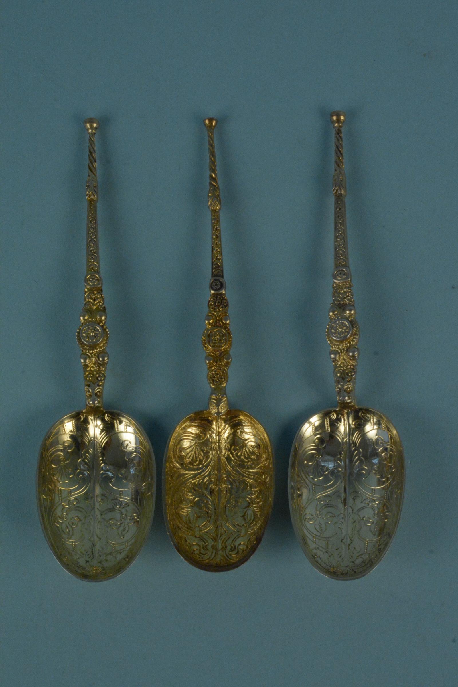 A pair of silver gilt anointing spoons together with another, all hallmarked London 1901,