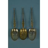 A pair of silver gilt anointing spoons together with another, all hallmarked London 1901,