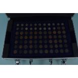 An aluminium coin case containing old copper farthings, an 1846 half crown,