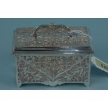 A silver plated jewellery box with silk lined interior, ornate floral decoration to each panel,