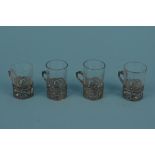A set of four continental silver shot glass holders with pierced and embossed decoration,
