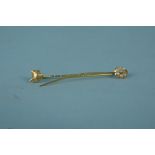 A yellow metal fox head stick pin with diamond set eyes together with an 18ct gold seed pearl set