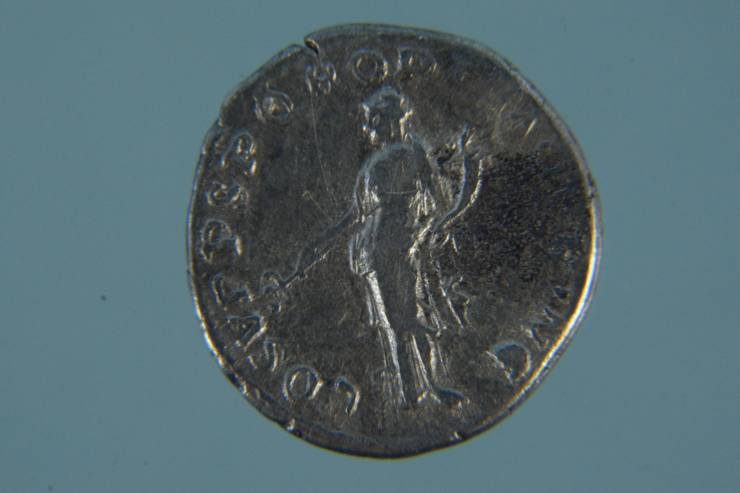 A silver coloured Roman coin (possibly Denarius)