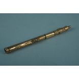 A yellow metal propelling pencil/fountain pen (as found)