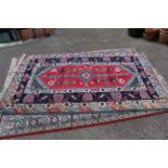 A hand woven wool multi colour rug approx.