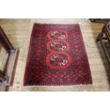 A red ground wool rug, approx.