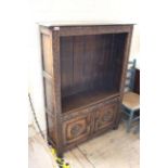 A 20th Century carved oak adjustable bookcase with two door cupboard below