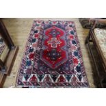 A mid 1980's Turkish red and green ground wool rug, approx.