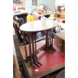 A nest of three mahogany tables with oval tops