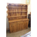 A bespoke hardwood kitchen dresser with shelved top and drawer and cupboard base