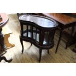 A 20th Century carved mahogany kidney shaped serving stand with tray to top