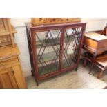 An early 20th Century glazed mahogany two door display cabinet