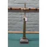 A tall brass finish Corinthian column double lamp on stone base, 70cm high (wear to finish,