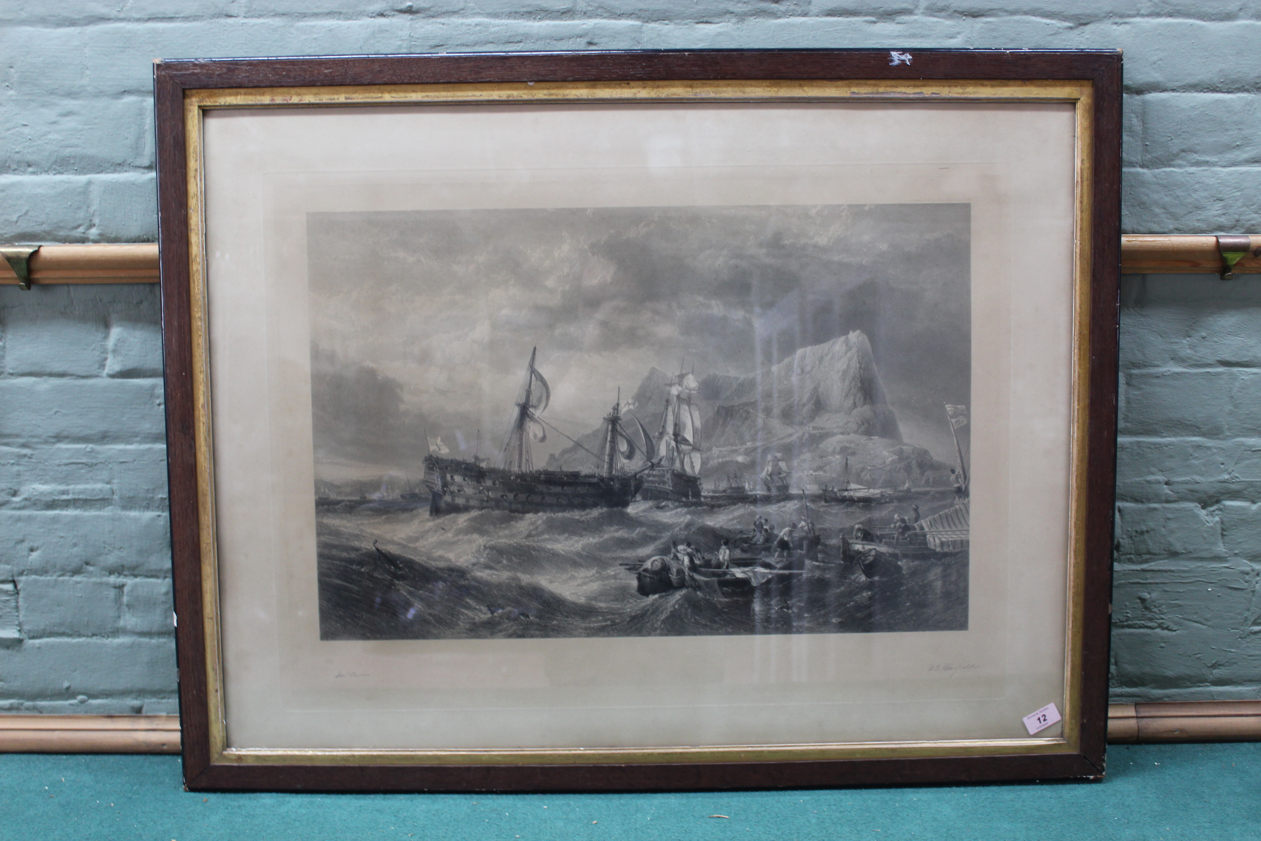 A large late 19th Century black and white print of ships off rocky shore with supply boats in