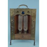 An Arts and Crafts/Nouveau period double heater fashioned from brass and copper and inset with a