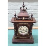 An early 20th Century oak cased German clock with enamel dial and brass decoration throughout,