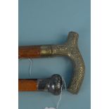 A hallmarked silver topped walking cane (some dents to silver) plus a brass handled cane