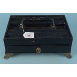 A late 19th Century black finish wooden inkstand with brass feet, swing handle and drawer,