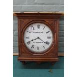 An early 20th Century carved oak wall clock,