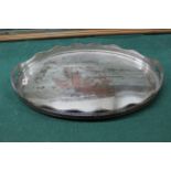 A silver plated on copper oval tray with pierced gallery having integral handles and four feet,