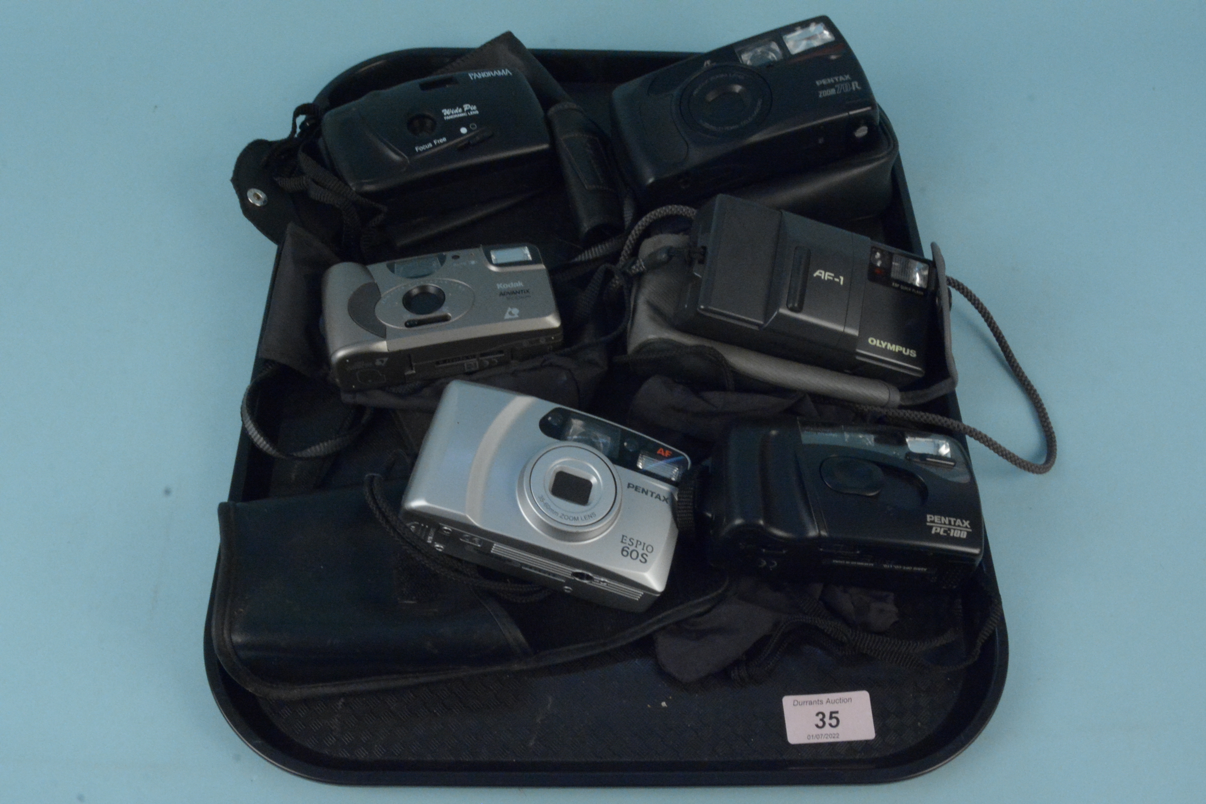 Six vintage 35mm cameras including Olympus AF-1, three Pentax,