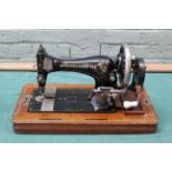 A vintage Frister and Rossmann sewing machine in a walnut case