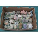 A collection of approx twenty five resin model cottages,