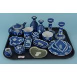 A collection of eighteen Wedgwood blue and white Jasperware pieces including a pair of candlesticks,