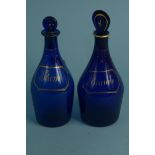 Two 19th Century Bristol blue glass decanters, one with original lozenge shape stopper,