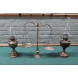 Two vintage brass oil lamps plus a brass set of balance scales