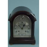 A late 19th Century Vokes of Bath mahogany cased chiming mantel clock, Roman numeral face with key,