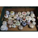 A quantity of small porcelain lidded jars, pill boxes,