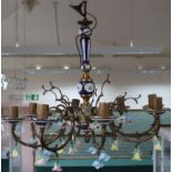 An unusual large brass and ceramic eight branch electrolier light fitting with individual ceramic