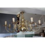A modern cast metal and brass eight light electrolier in the Dutch fashion with applied dolphin