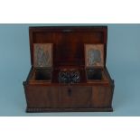 A mid 19th Century mahogany tea caddy with fitted interior and mixing bowl and turned ring handles