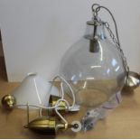 A large clear glass light fitting plus a brass light fitting