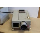 A vintage cased Leitz slide projector with manual