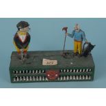 A reproduction cast iron 'Birdie Putt' golf themed money box