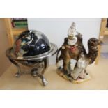 A large Capodimonte figural group of an Arabian couple leading a camel plus a 20th Century table