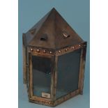 A large Arts and Crafts copper wall mounted lantern of rectangular tapering form with pitched