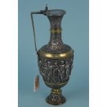 An ornate Victorian claret jug elaborately decorated all over with semi clad figures,