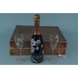 A 1978 boxed Perrier Jouet bottle of champagne with two of four matching glasses (box with signs of