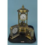 A vintage brass torsion clock (lacking dome,