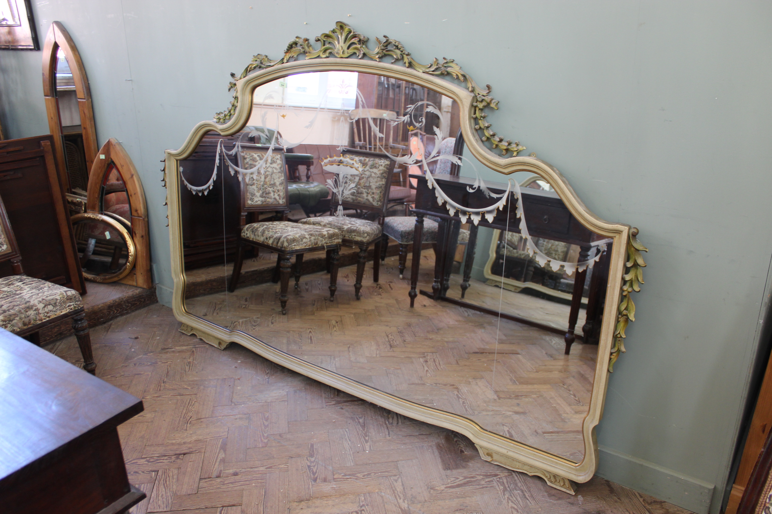 A substantial painted overmantel mirror with etched glass decoration