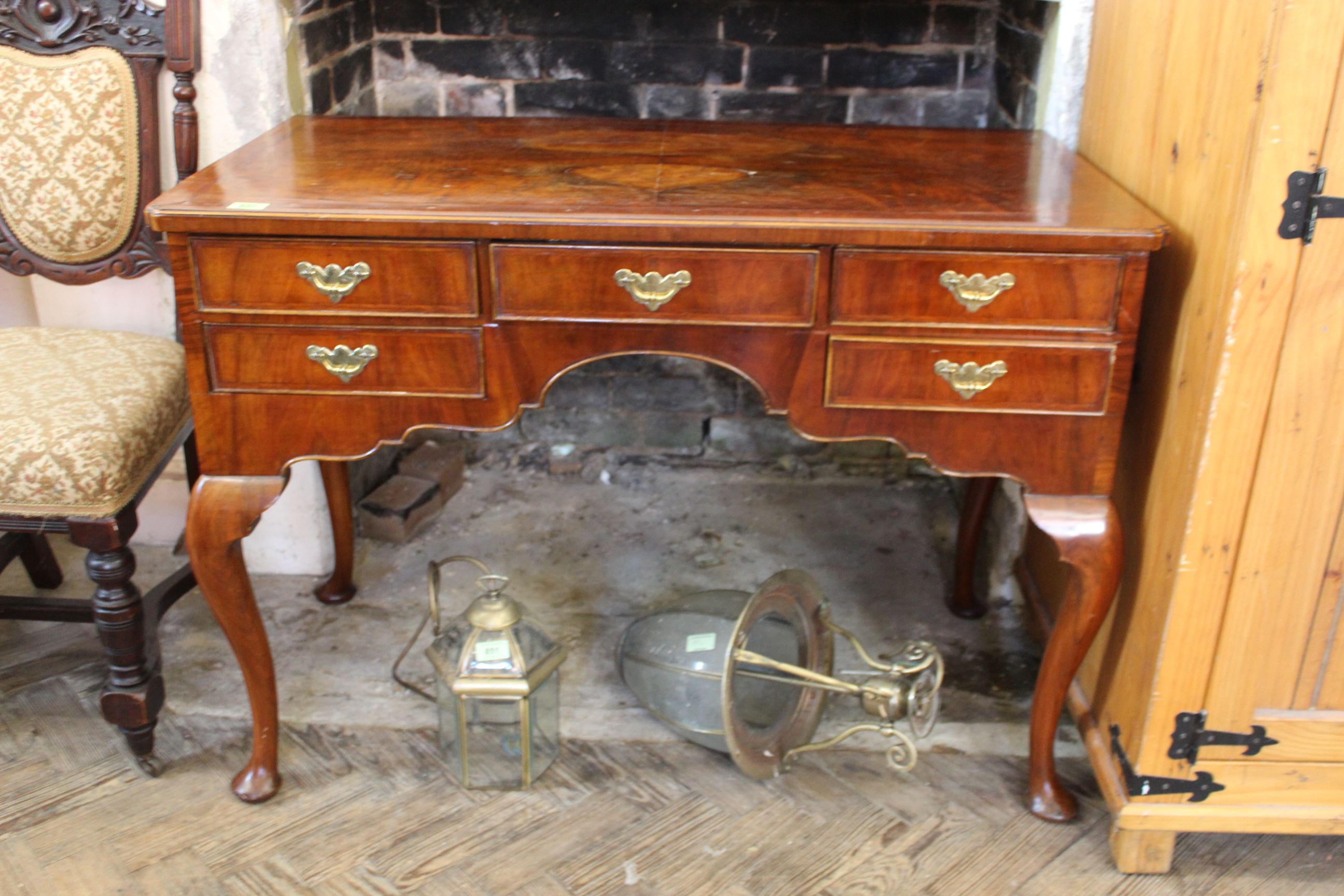 A Queen Anne style five drawer walnut dressing table