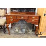 A Queen Anne style five drawer walnut dressing table