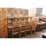 A substantial modern mangowood and iron dining table with eight chairs