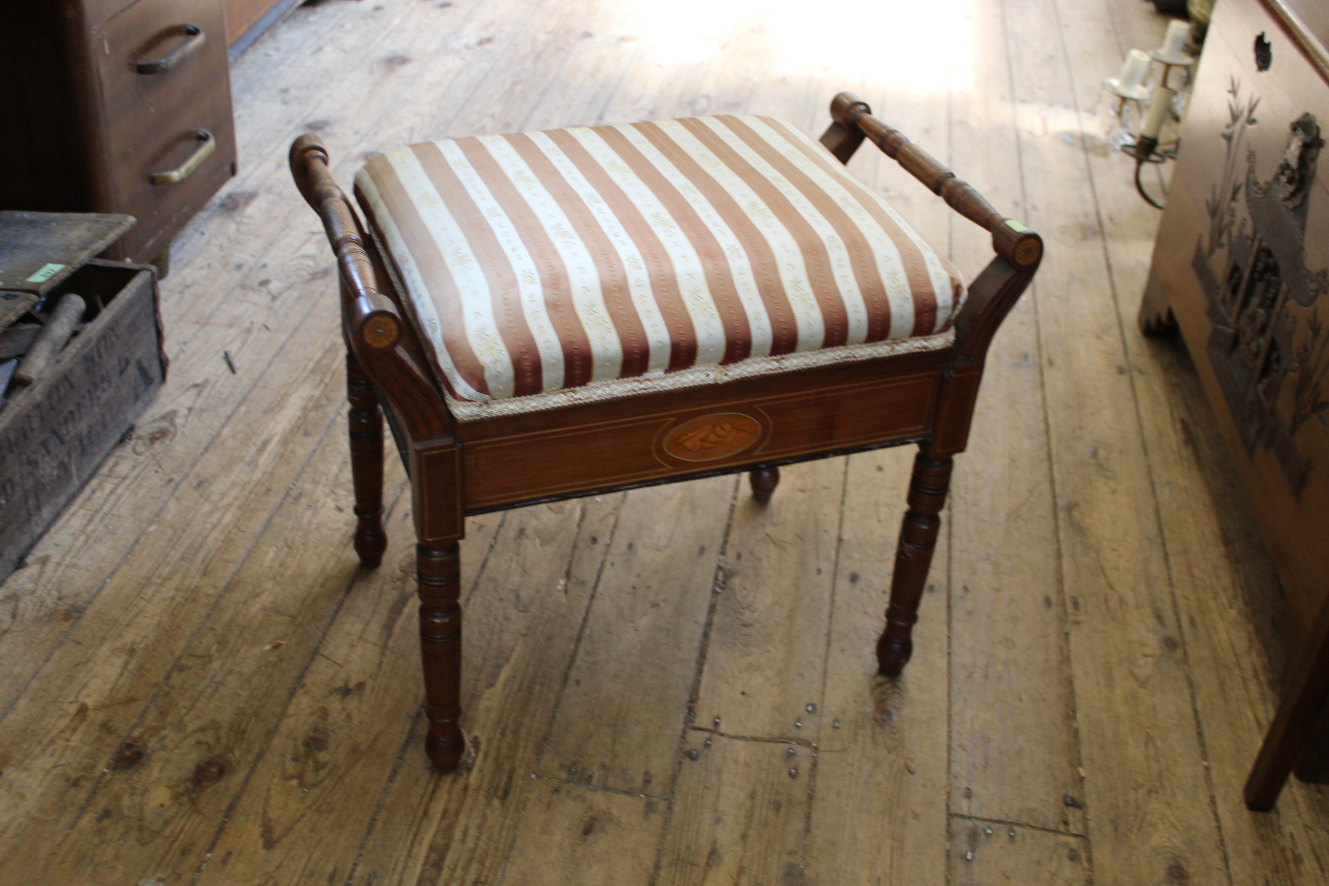 An inlaid mahogany Edwardian upholstered piano stool