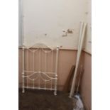 A modern white painted metal single bed frame