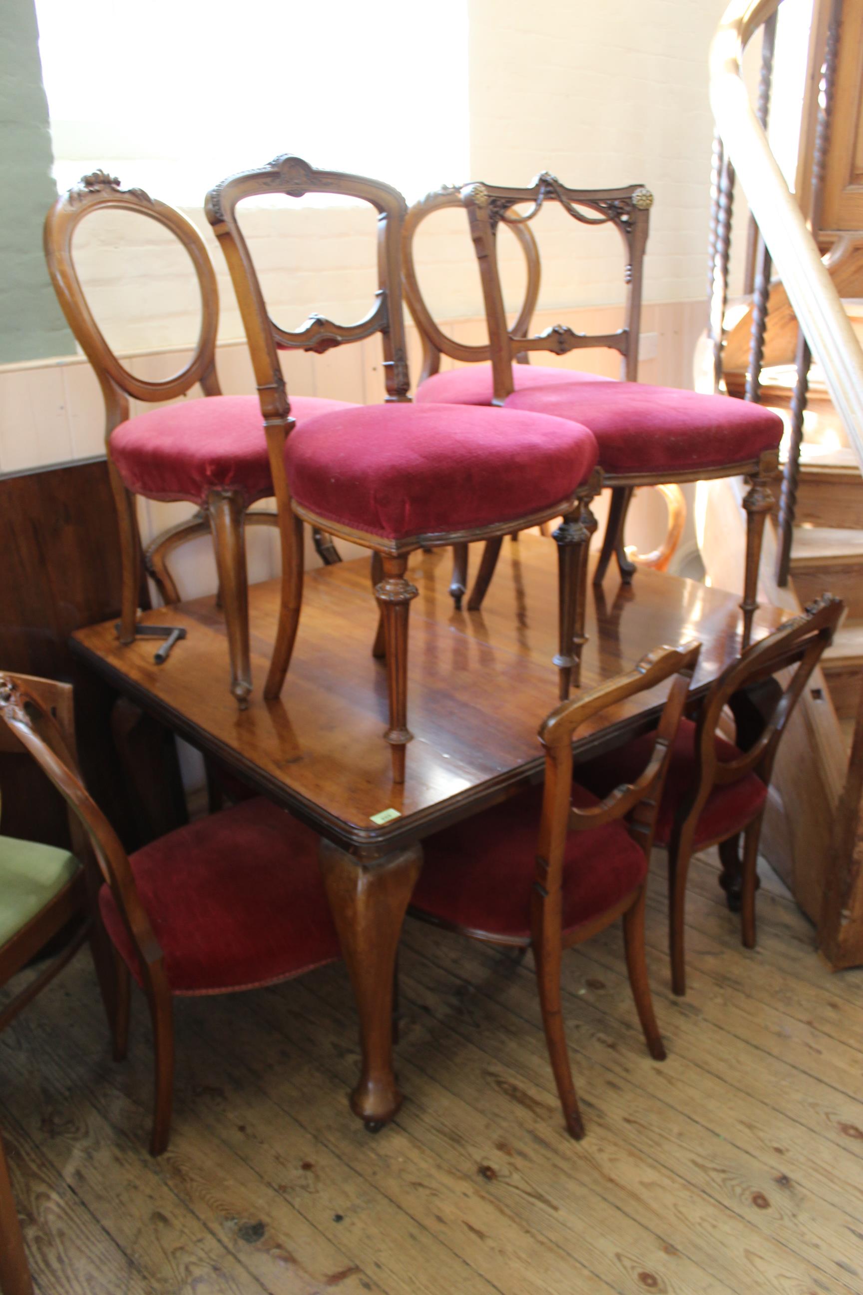 A late Victorian extending mahogany dining table with ten assorted chairs